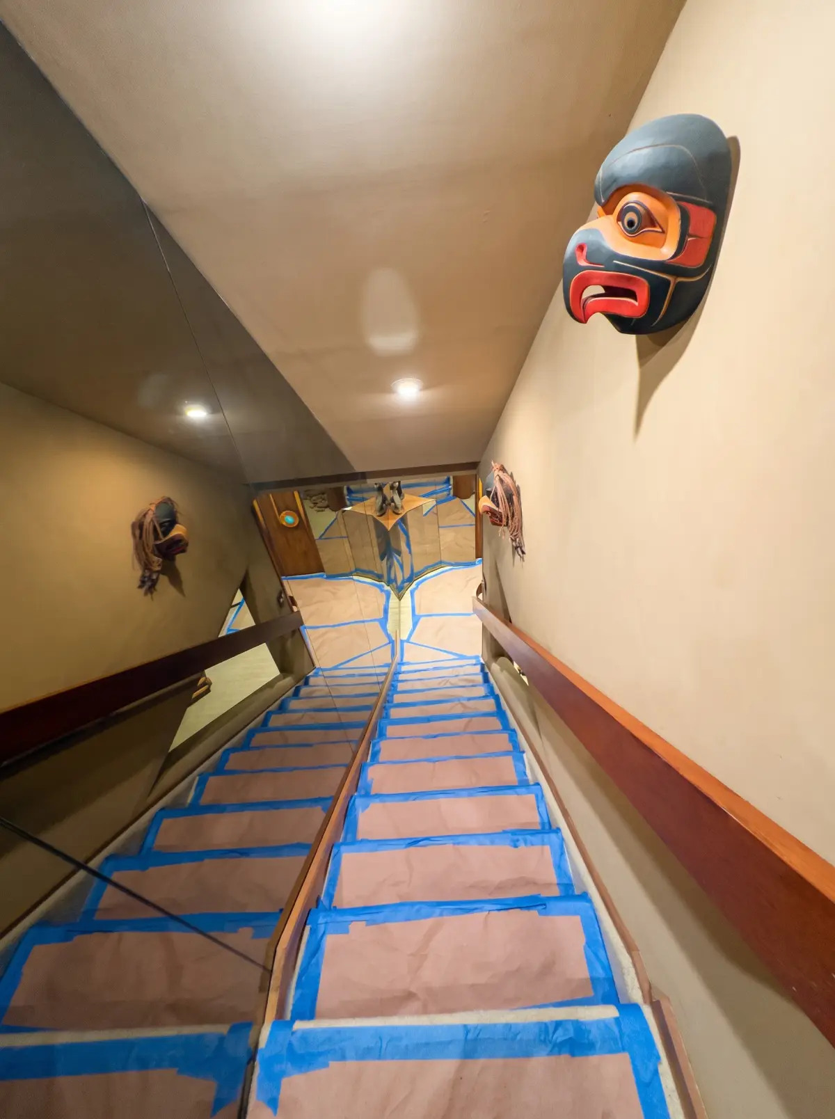 Stairs covered with protective runners leading up to a work area