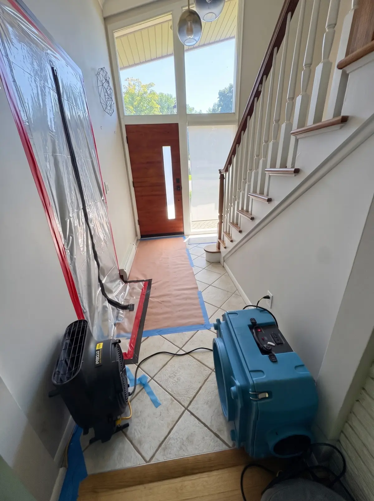 Foyer with plastic containment, floor protection and drying equipment