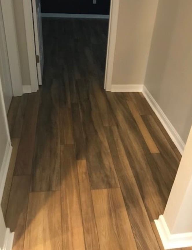 Finished plank flooring running through a hallway after a rebuild, published on Prime's Google Business Profile