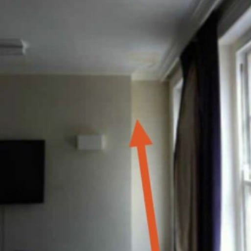A ceiling corner photographed normally. It looks clean and dry.